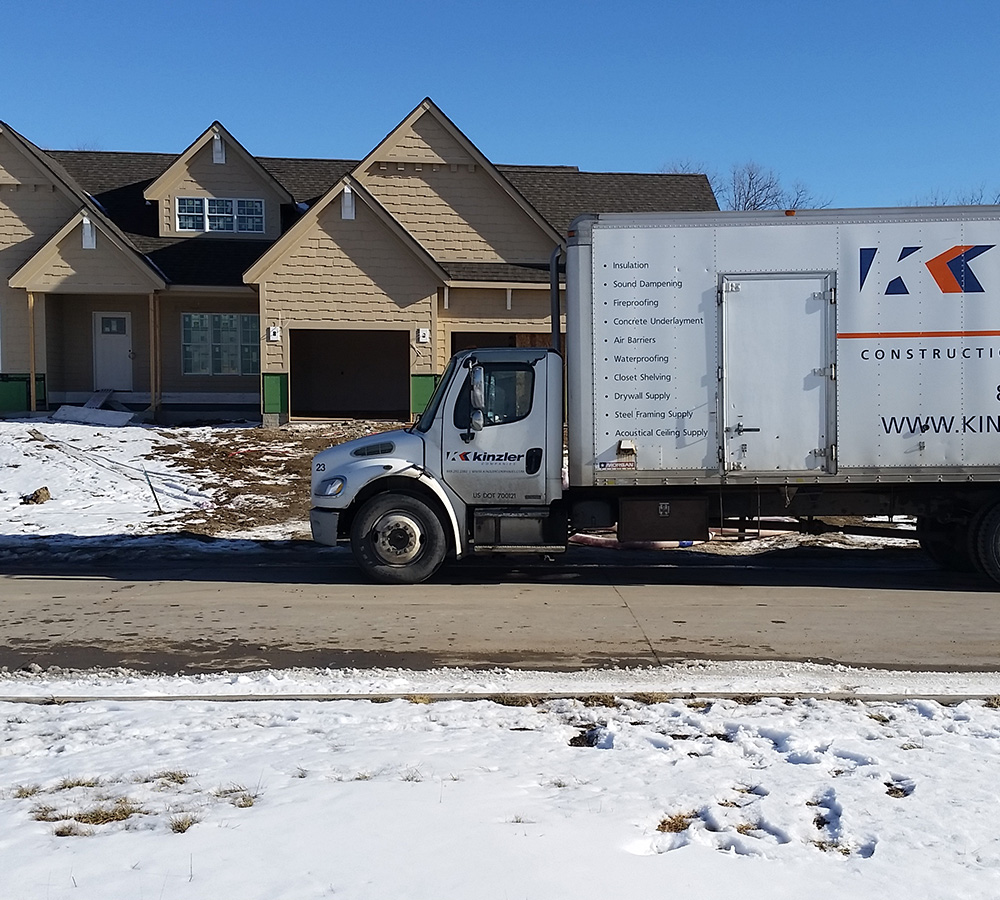Kinzler Construction Services truck in front of a home